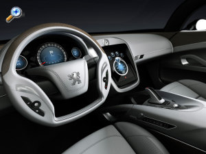 amnagement intrieur du concept-car PEUGEOT 908 RC: Voici une vue du tableau de bord de la Peugeot 908 RC. L'aspect luxe de cet intrieur se marque par des matriaux nobles: cuir de diffrentes couleur claires et aluminium, en oubliant les bois prcieux pour confrer  ce concept-car Peugeot 908 RC un aspect futuriste. Nul doute qu'une ventuelle dclinaison srie de ce concept-car sous la forme d'une Peugeot 608 par exemple proposerait des inserts de bois. <br>
Le volant est imposant, et regroupe quelques commandes.